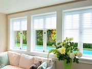 Light filtering white fabric blinds.